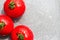 Fresh red tomatoes with drops on a plate background