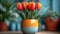 Fresh red tulips in a speckled orange and yellow ceramic vase on a wooden table