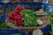 Fresh Red Turnip with green leaves on flat rattan basket