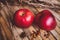 Fresh red two couple apple on brown rustic board