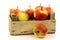 Fresh red and yellow apples in a wooden box