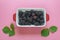 Fresh ripe blackberries, pink paper background. Flat lay. Copy space