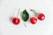 Fresh ripe cherries with green leav on the white wooden background. Top view. Copy, empty space for text