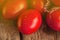 Fresh ripe delicious Roma tomatoes on wooden background