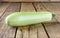 Fresh ripe delicious zucchini on wooden table