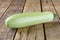 Fresh ripe delicious zucchini on wooden table