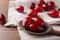 Fresh ripe dogwood berries, spoon and towel on wooden table, closeup