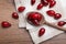 Fresh ripe dogwood berries, spoon and towel on wooden table, flat lay