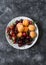 Fresh ripe fruit - apricots, cherries, strawberries on a dark background, top view