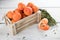 Fresh ripe Italian tangerines in a wooden box on a white background