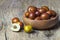 Fresh ripe jujube fruits in bowl on wooden rustic background