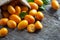 Fresh ripe kumquat fruits in burlap sack on wooden background