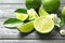 Fresh ripe limes on wooden table. Citrus fruit