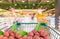 Fresh ripe litchi fruits in shopping trolley cart in supermarket
