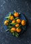 Fresh ripe mandarins on blue background, top view. Free space