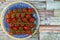 Fresh ripe mini marzano tomatoes on blue plate