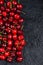 Fresh ripe organic cherries on black border background