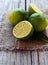 Fresh ripe organic limes on burlap cloth on wooden table.Lime fruits.Diet or aromatherapy concept.