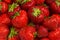 Fresh ripe organic strawberry. Mashed ripe strawberries background. Top view,