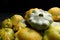 Fresh ripe pattypan squashes on dark background, closeup
