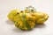 Fresh ripe pattypan squashes on white wooden table, closeup