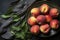 fresh ripe peaches with leaves in a bowl on a wooden table, top view