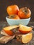 Fresh ripe persimmons on a wooden table.