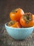 Fresh ripe persimmons on a wooden table. Selective focus