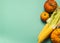 Fresh ripe pumpkin and corn on a mint blue background. Thanksgiving Autumn Concept. Flat layout. Empty place for text