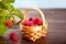 Fresh ripe raspberries in a tiny basket
