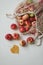 Fresh ripe red apples in a eco mesh shopping bag on a white background. Zero waste, no plastic. Autumn flatlay