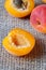 Fresh ripe slice and whole apricot closeup