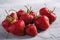 Fresh ripe strawberry fruits, summer vitamin berries on grey stone background
