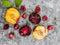 Fresh ripe summer berries and fruits, peaches, apricots, cherry and plum in a round plate on the table