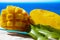 Fresh ripe sweet yellow mango fruit served on glass plate with blue seaview background