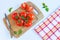 Fresh and ripe tomatoes, basil and knife on cutting board