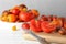 Fresh ripe tomatoes, cutting board and knife on white