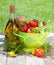 Fresh ripe tomatoes, olive oil bottle, pepper shaker and basil