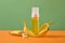 Fresh ripe yellow bananas with slices and pump bottle unlabeled decorated on green background.