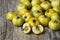 Fresh ripe yellow hawthorn fruits on wooden rustic background