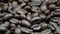 Fresh roasted coffee beans at lamp light extreme closeup