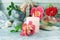 Fresh rose flowers and petal tincture, sea shells and stones, burning candles, on a wooden table, spa concept