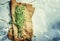 Fresh rosemary in a bundle on a canvas napkin, gray food background, top view