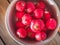 Fresh round radish in an aluminum plate close-up top view