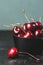 Fresh ruby cherries on black background. Dark moody close up still life