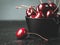 Fresh ruby cherries on black background. Dark moody close up still life