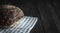 Fresh rye bread on black wooden table