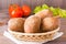 Fresh rye buns in a basket, salad and tomato