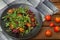 Fresh salad with arugula, shrimp, cherry tomato and avocado. Wooden background. Close-up. Top view