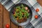 Fresh salad with arugula, shrimp, cherry tomato and avocado. Wooden background. Close-up. Top view